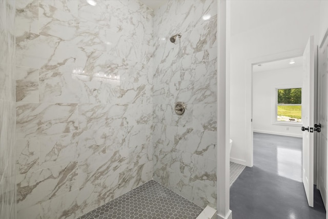 bathroom featuring a tile shower and concrete flooring