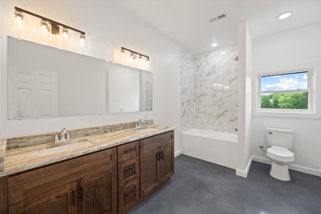 full bathroom featuring concrete floors, tiled shower / bath combo, vanity, and toilet