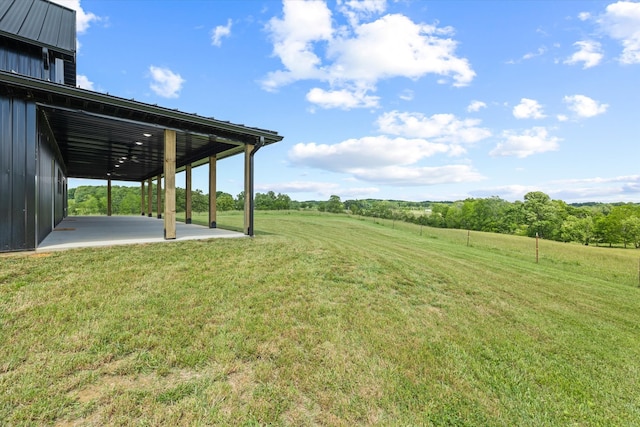 view of yard featuring a rural view and a patio