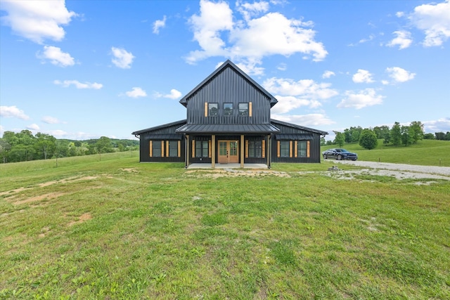 back of house with a lawn