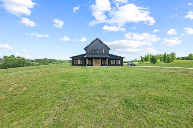 view of front facade with a rural view and a front yard