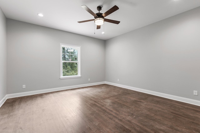 spare room with ceiling fan and dark hardwood / wood-style flooring