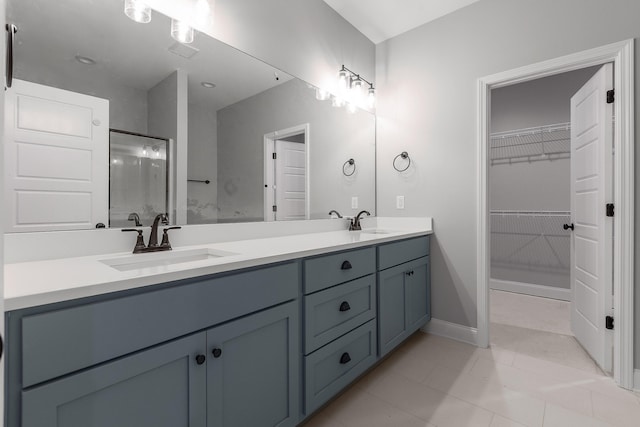 bathroom with an enclosed shower, tile patterned floors, and vanity