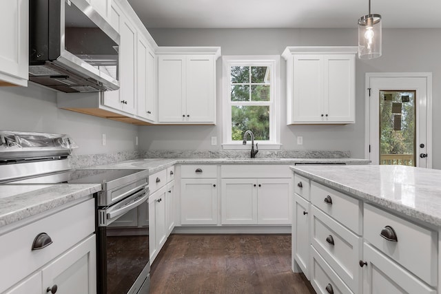 kitchen with stainless steel appliances, white cabinets, and a healthy amount of sunlight