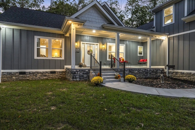 exterior entry at dusk with a lawn