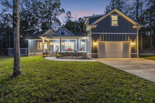 craftsman-style house featuring a garage, a lawn, and a porch