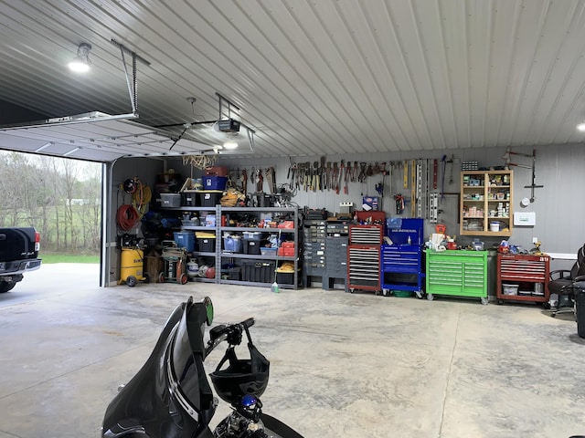 2175 Winsett Rd, Springville, TN 38256 - garage with a workshop area and a garage door opener