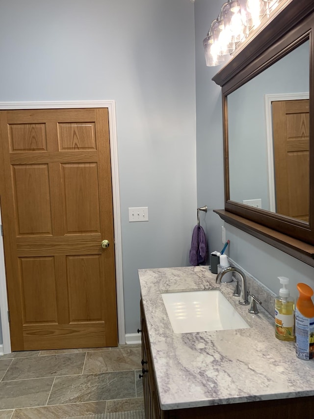 2175 Winsett Rd, Springville, TN 38256 - bathroom with vanity, baseboards, and stone finish floor