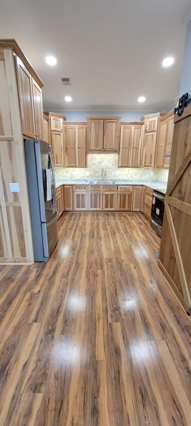 2175 Winsett Rd, Springville, TN 38256 - kitchen with freestanding refrigerator, a sink, wood finished floors, and decorative backsplash