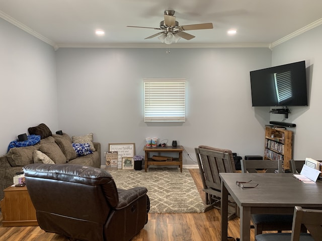 living room featuring wood-type flooring, ornamental molding, and ceiling fan