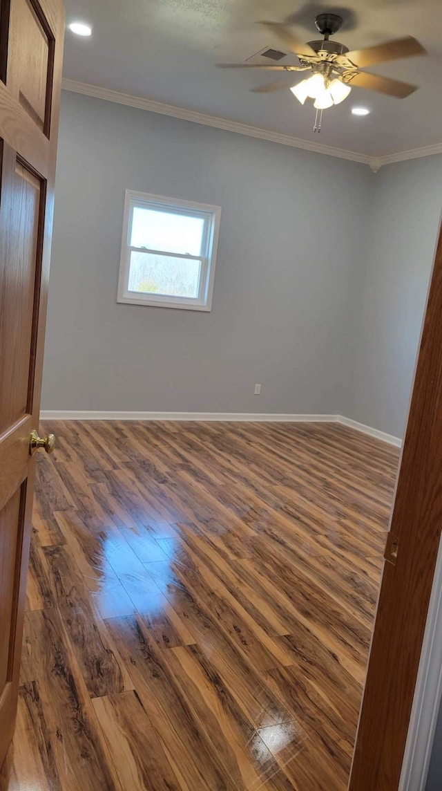 unfurnished room with ornamental molding, ceiling fan, and dark hardwood / wood-style floors