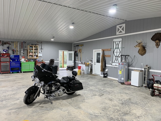 garage with water heater and a workshop area