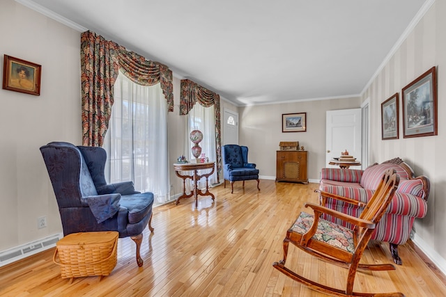 sitting room featuring light hardwood / wood-style floors and crown molding