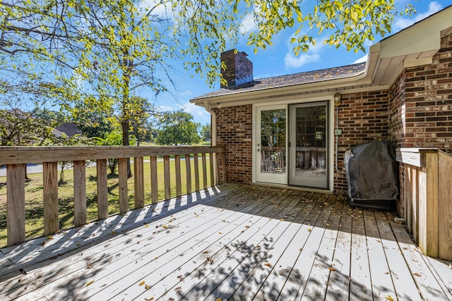 wooden terrace featuring grilling area