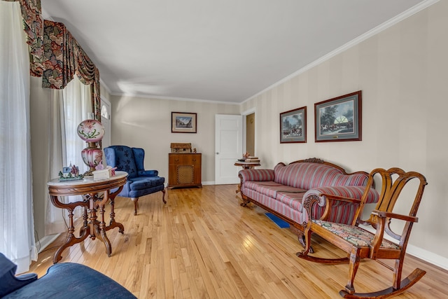 living room with ornamental molding and light hardwood / wood-style floors