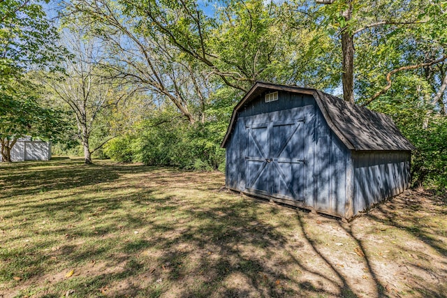 view of outbuilding with a lawn