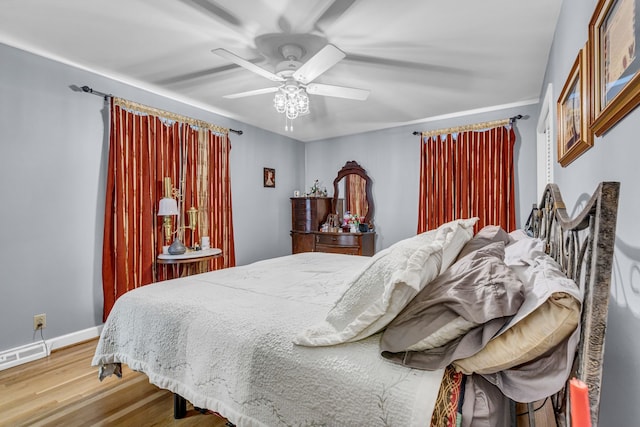 bedroom with hardwood / wood-style floors and ceiling fan