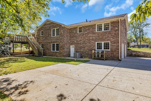 back of property featuring a deck, a lawn, a patio, and central AC