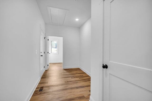 corridor with light hardwood / wood-style flooring