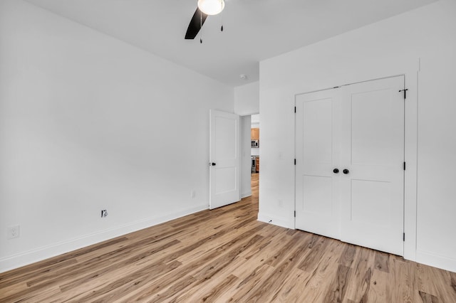 405 Boone Pass, Jasper, TN 37347 - unfurnished bedroom with light wood-style flooring, a closet, baseboards, and a ceiling fan