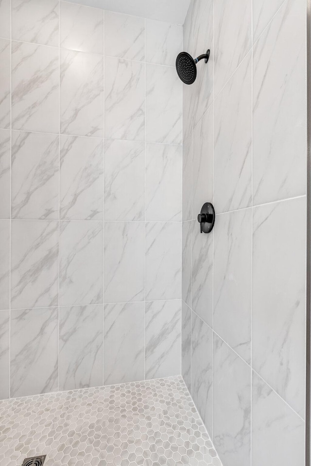 bathroom with a tile shower