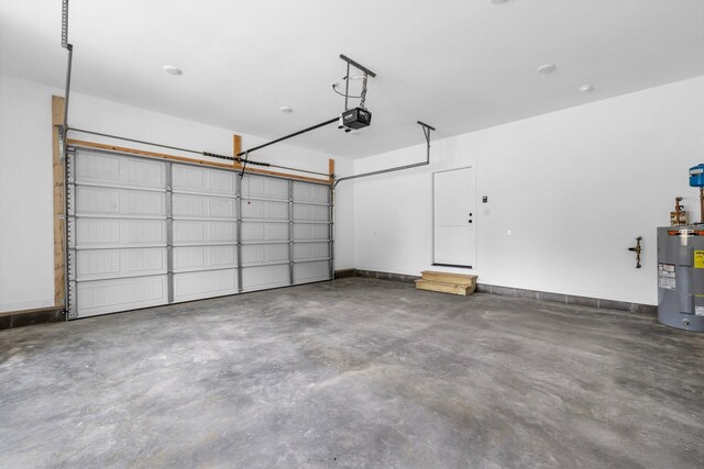 405 Boone Pass, Jasper, TN 37347 - garage featuring electric water heater and a garage door opener