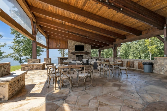 view of patio featuring an outdoor stone fireplace