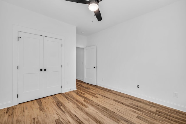 405 Boone Pass, Jasper, TN 37347 - unfurnished bedroom featuring light wood finished floors, baseboards, a ceiling fan, and a closet