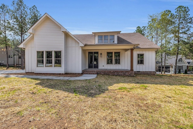 405 Boone Pass, Jasper, TN 37347 - view of front of property with board and batten siding, roof with shingles, a porch, and a front lawn
