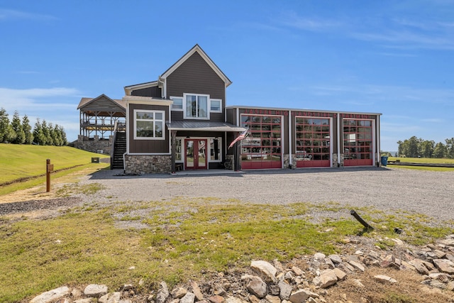 back of property featuring french doors and a lawn