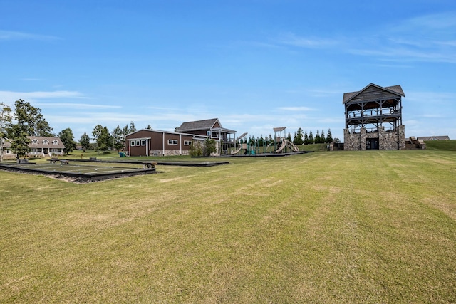 view of home's community with a yard and a playground