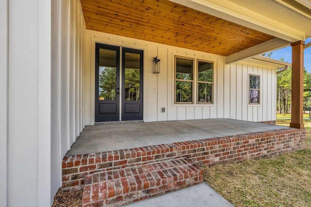 405 Boone Pass, Jasper, TN 37347 - view of exterior entry with board and batten siding, french doors, and covered porch