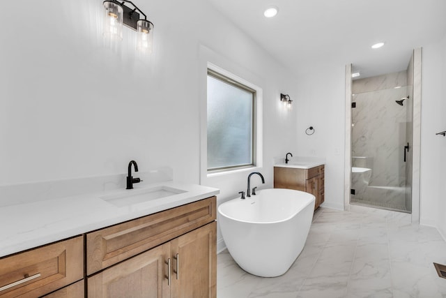 bathroom featuring shower with separate bathtub and vanity