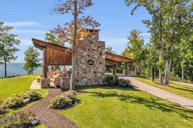 view of property's community featuring a water view and a yard