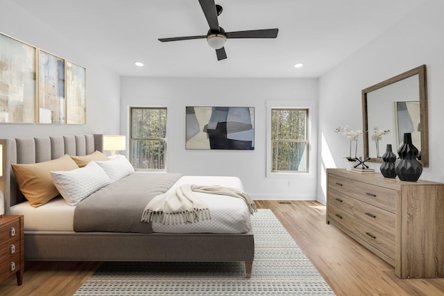 bedroom featuring light hardwood / wood-style floors and ceiling fan