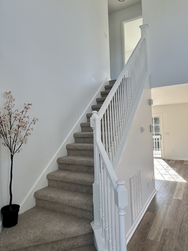 stairway with hardwood / wood-style floors