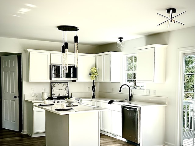 kitchen featuring white cabinetry, appliances with stainless steel finishes, a center island, dark hardwood / wood-style flooring, and sink