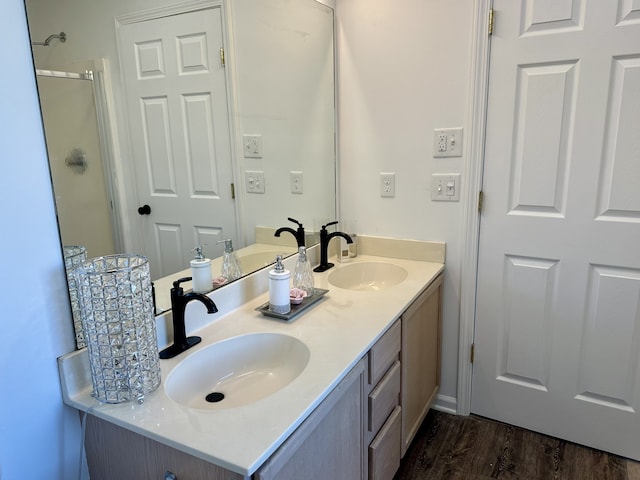 bathroom featuring a shower with shower door, vanity, and wood-type flooring