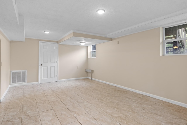 basement featuring a textured ceiling