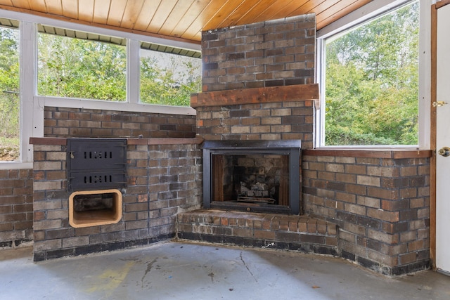 unfurnished living room with wood ceiling, a wealth of natural light, and concrete floors