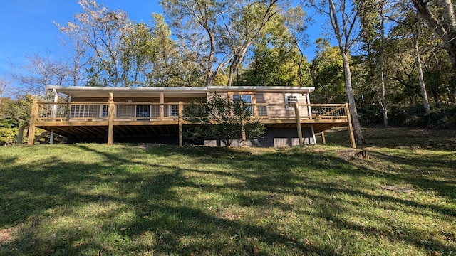 back of property with a lawn and a deck