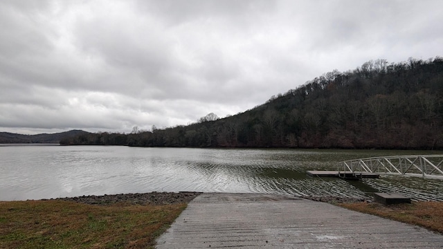 view of dock with a water and mountain view