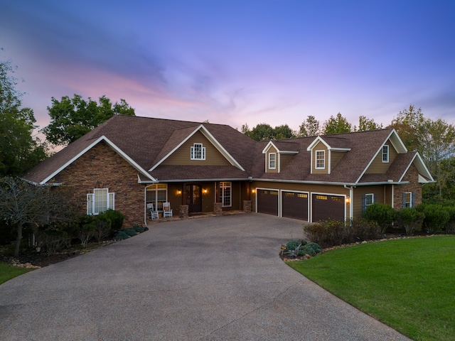 craftsman house featuring a garage, a yard, and covered porch