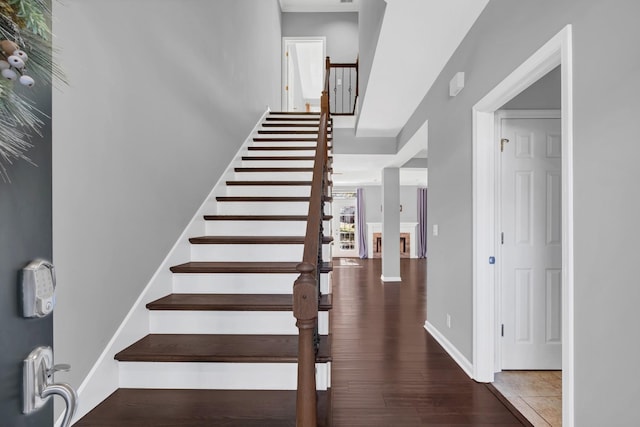 stairs with baseboards and wood finished floors