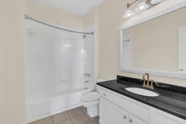 bathroom featuring toilet, tile patterned flooring, vanity, and shower / bathing tub combination
