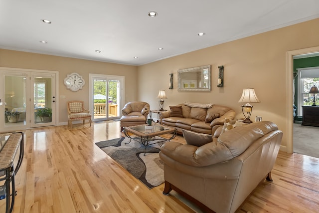 living room with light hardwood / wood-style floors and ornamental molding