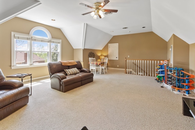 carpeted living room featuring ceiling fan and vaulted ceiling