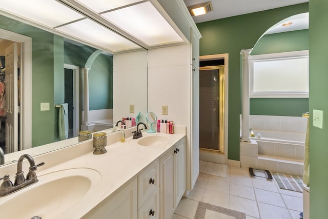 bathroom with tile patterned floors, vanity, and separate shower and tub