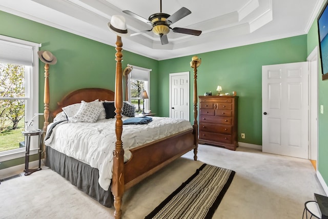 bedroom with ceiling fan, light colored carpet, a closet, and a raised ceiling