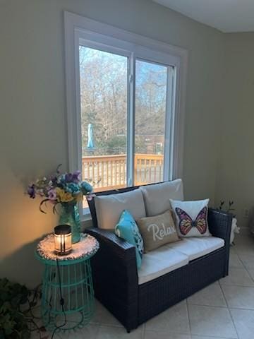 sitting room with a healthy amount of sunlight and light tile patterned floors